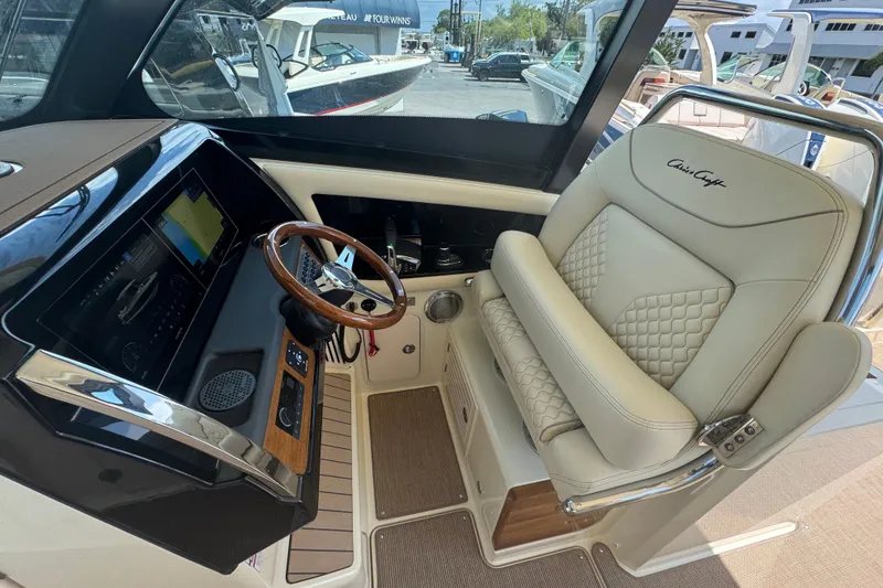 Slide: The Image of Luxurious helm of 2026 Chris-Craft Calypso 32 with leather seating and advanced controls. - 9