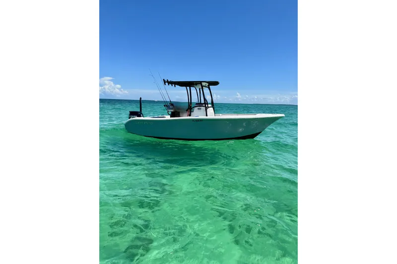 The Image of 2018 Sea Pro 219 Center Console boat on clear turquoise water under blue sky. - 0