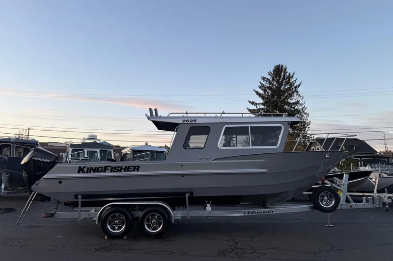 The Image of 2026 KingFisher 2625 Coastal Express boat on trailer at sunset. - 1