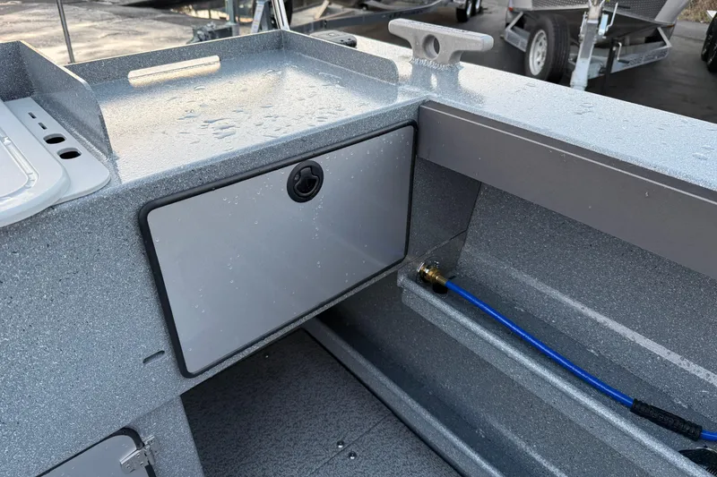 Slide: The Image of Interior view of 2026 KingFisher 2625 Coastal Express boat with storage compartment. - 10