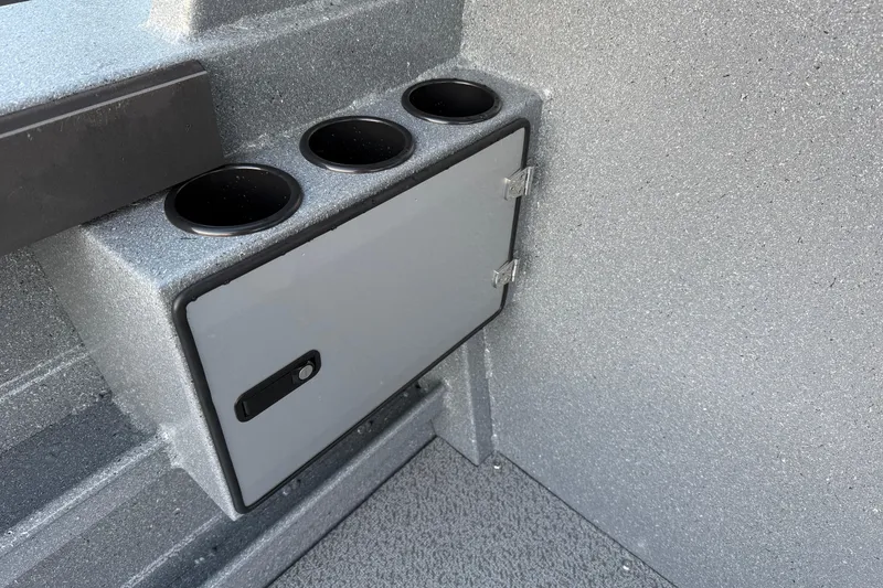 Slide: The Image of Interior of 2026 KingFisher 2625 Coastal Express boat with cup holders and storage compartment. - 11