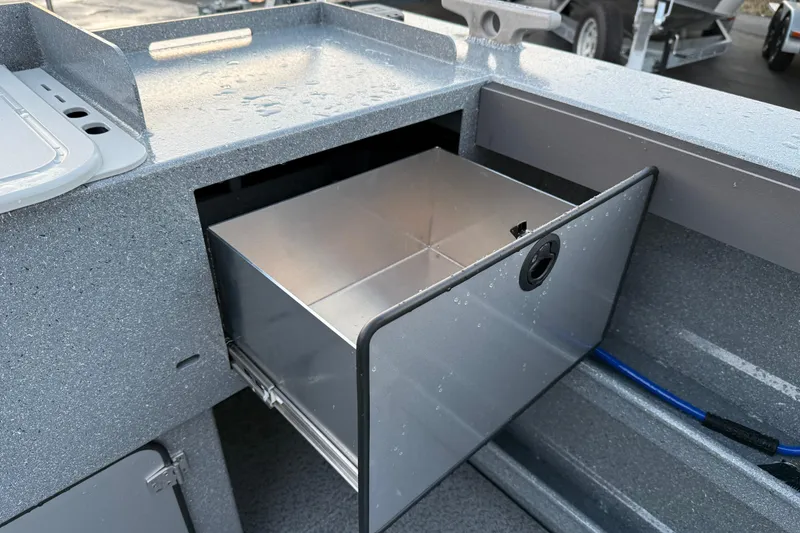 Slide: The Image of KingFisher 2625 Coastal Express 2026 boat storage compartment with open drawer. - 12
