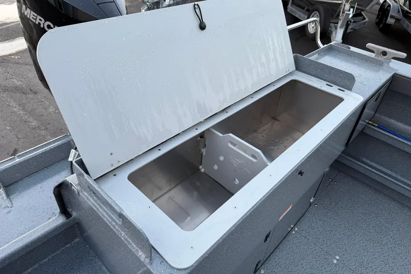Slide: The Image of Open storage compartment on 2026 KingFisher 2625 Coastal Express boat, showcasing interior space. - 13
