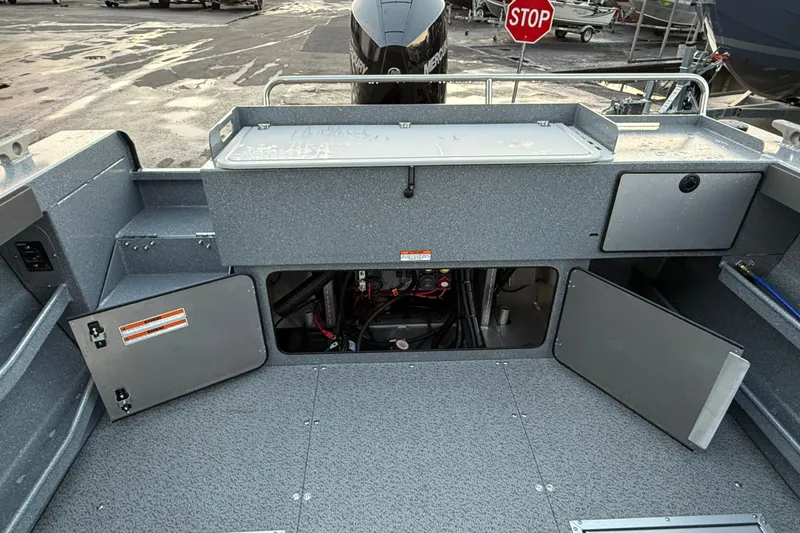 Slide: The Image of 2026 KingFisher 2625 Coastal Express boat interior with open storage compartments. - 16