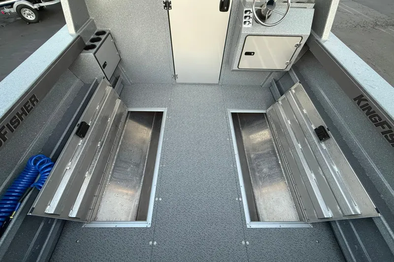 Slide: The Image of Interior of 2026 KingFisher 2625 Coastal Express boat with storage compartments and steering console. - 17