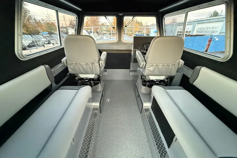 Slide: The Image of Interior of 2026 KingFisher 2625 Coastal Express boat with seating and steering wheel. - 20