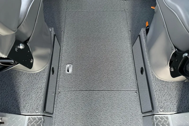 Slide: The Image of Interior view of 2026 KingFisher 2625 Coastal Express boat, featuring gray seating and flooring. - 28