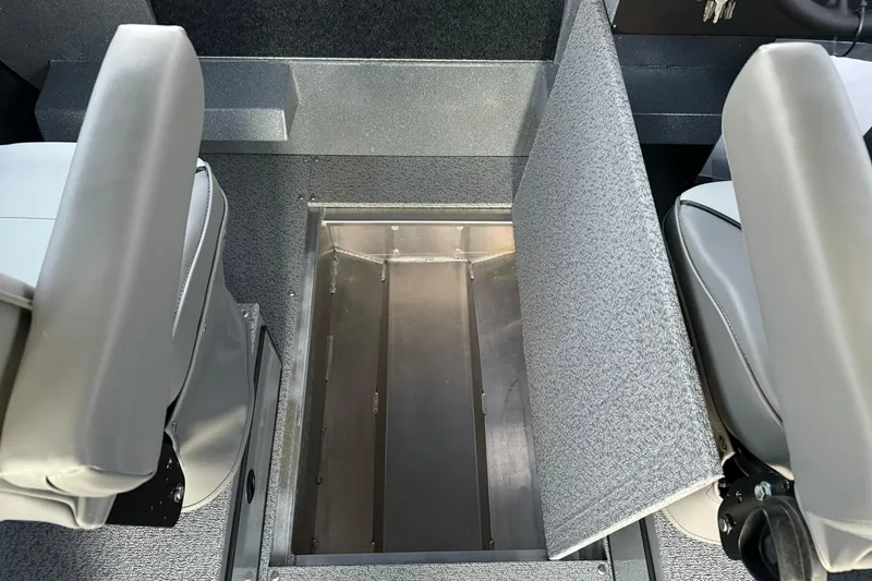 Slide: The Image of 2026 KingFisher 2625 Coastal Express interior storage compartment between seats. - 29
