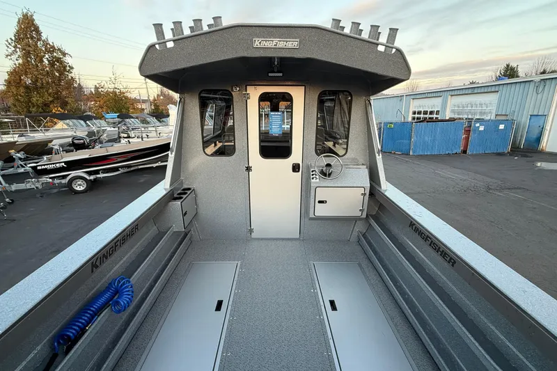 Slide: The Image of 2026 KingFisher 2625 Coastal Express boat interior, showcasing helm and cabin entrance. - 3