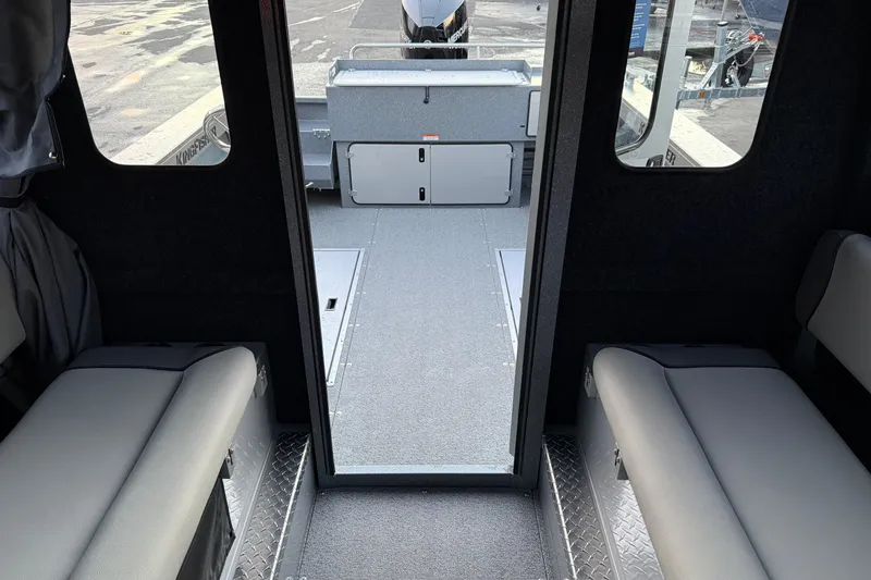 Slide: The Image of Interior view of 2026 KingFisher 2625 Coastal Express boat, featuring seating and storage compartments. - 32