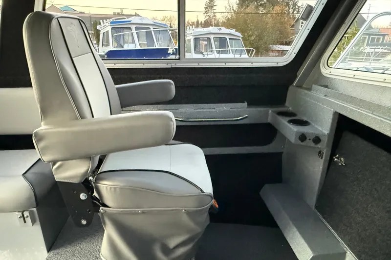 Slide: The Image of Interior of 2026 KingFisher 2625 Coastal Express boat with gray seating and window view. - 33