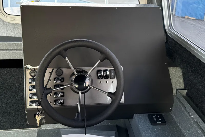 Slide: The Image of Steering wheel and control panel of 2026 KingFisher 2625 Coastal Express boat. - 38