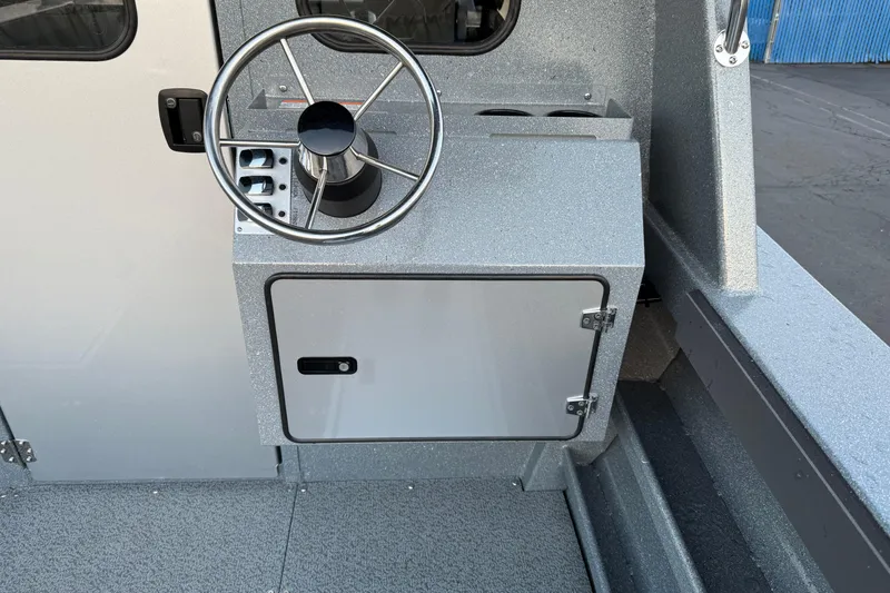 Slide: The Image of Steering console of 2026 KingFisher 2625 Coastal Express boat, featuring a sleek metallic finish. - 4