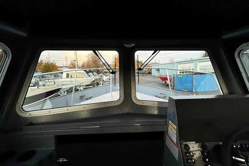 Slide: The Image of Interior view from the 2026 KingFisher 2625 Coastal Express boat, showcasing the dashboard and windows. - 40