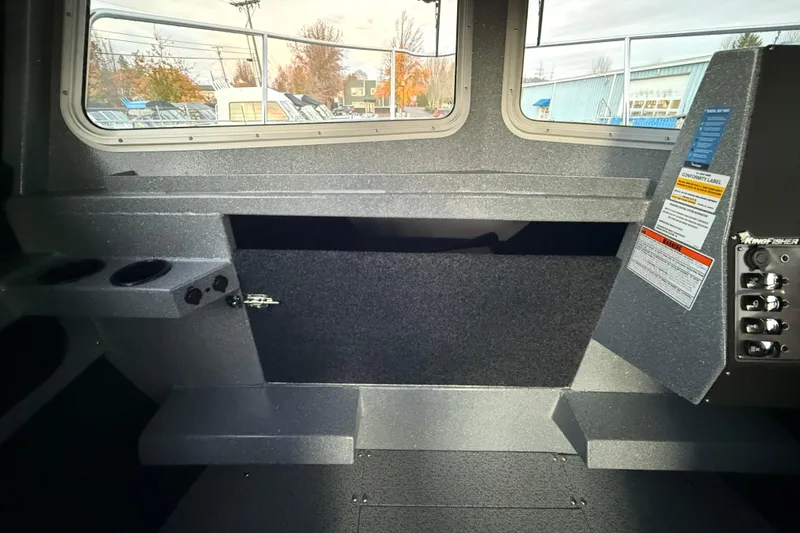 Slide: The Image of Interior of 2026 KingFisher 2625 Coastal Express boat, featuring control panel and windows. - 41