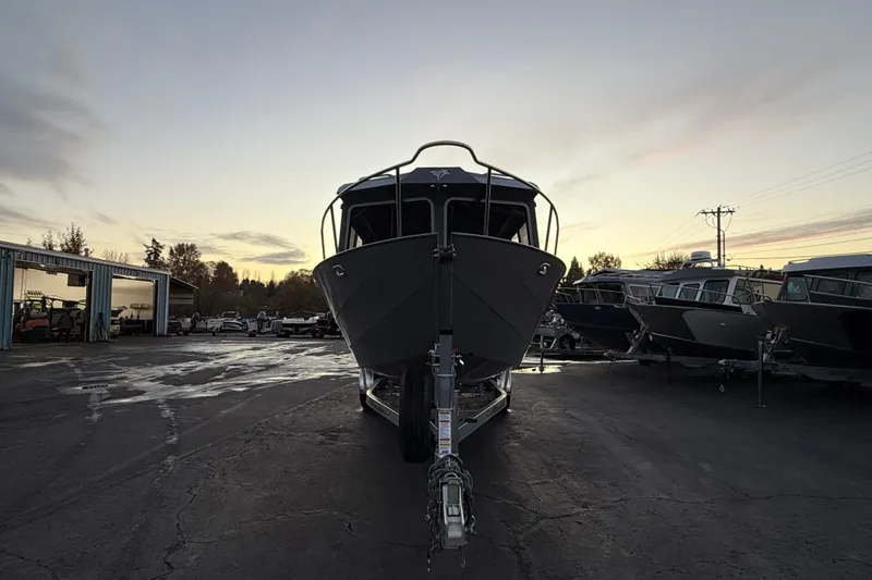 Slide: The Image of 2026 KingFisher 2625 Coastal Express boat on trailer at sunset in a parking lot. - 44