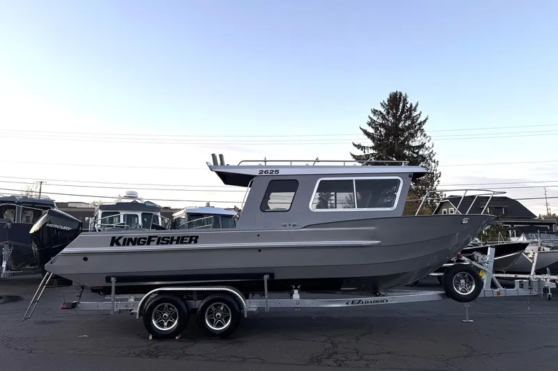 Slide: The Image of 2026 KingFisher 2625 Coastal Express boat on trailer, side view. - 47