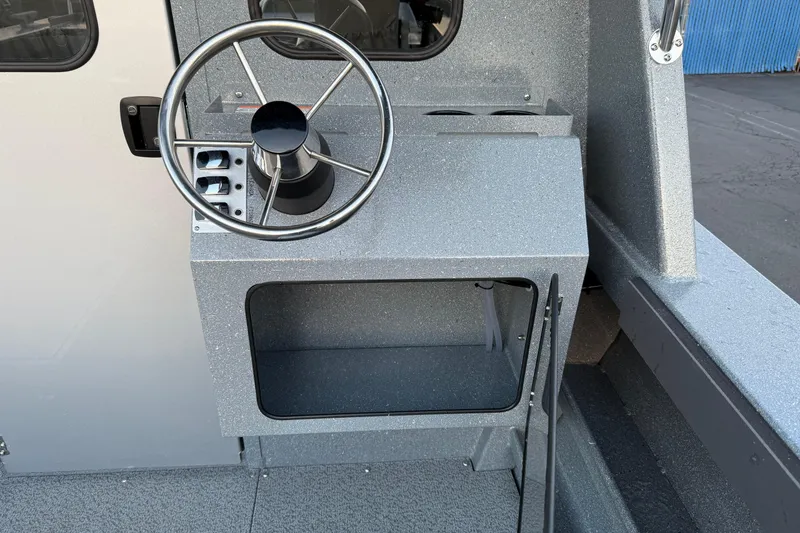 Slide: The Image of Steering console of 2026 KingFisher 2625 Coastal Express boat, featuring a sleek design. - 6