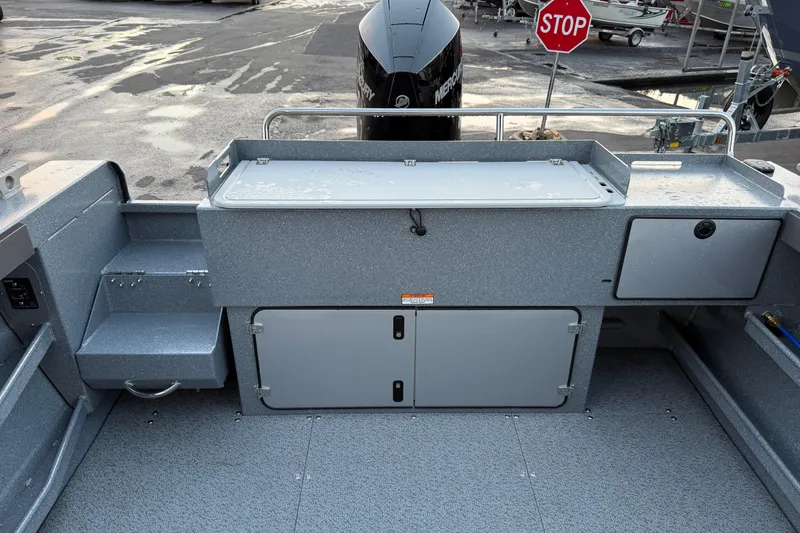 Slide: The Image of 2026 KingFisher 2625 Coastal Express boat interior with storage compartments and motor. - 7