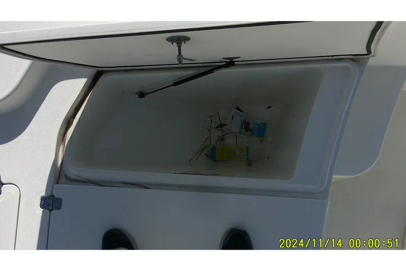 Slide: The Image of Open storage compartment on 2024 Mako Pro Skiff 19 CC boat. - 13