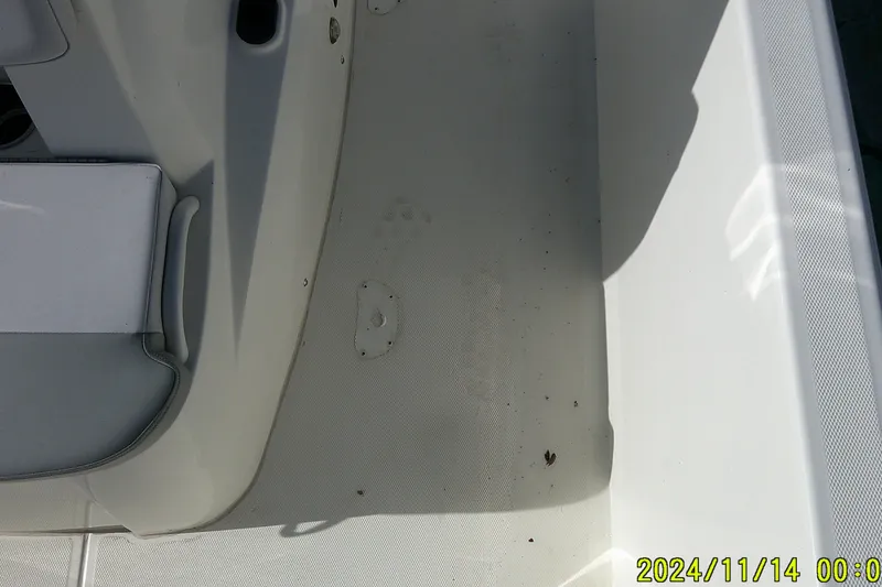 Slide: The Image of 2024 Mako Pro Skiff 19 CC boat interior, showing clean deck and seating area. - 19