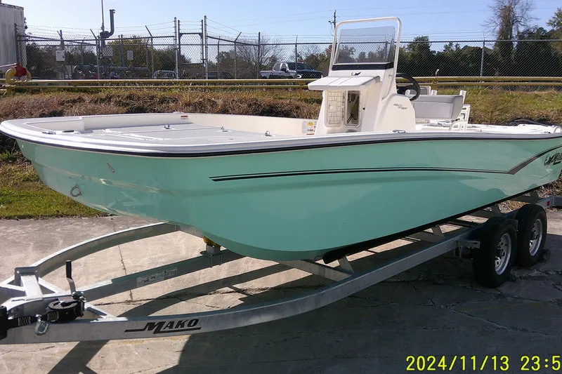 Slide: The Image of 2024 Mako Pro Skiff 19 CC boat on trailer, parked outdoors. - 2