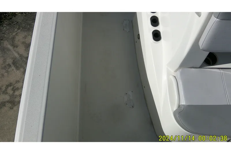 Slide: The Image of 2024 Mako Pro Skiff 19 CC interior view with seating and rod holders. - 20