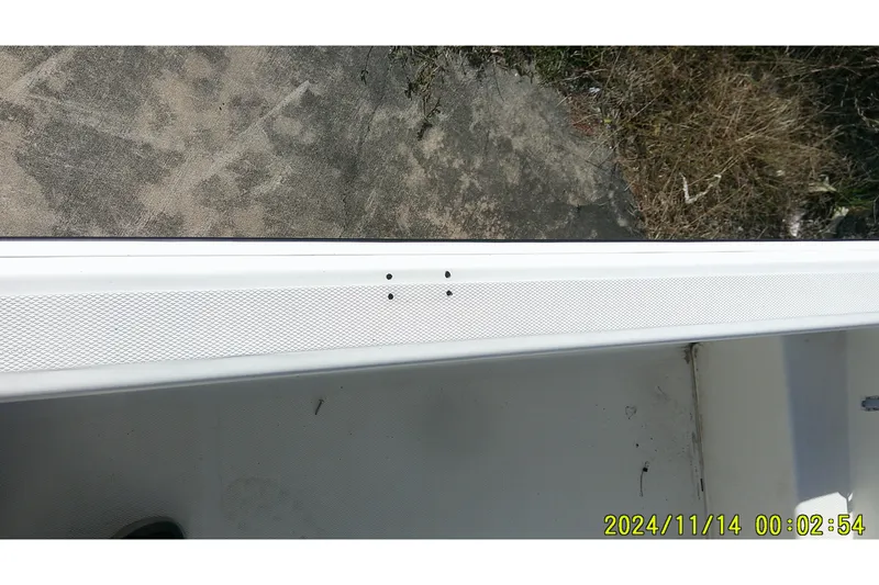 Slide: The Image of 2024 Mako Pro Skiff 19 CC boat detail with textured surface and visible screws. - 22