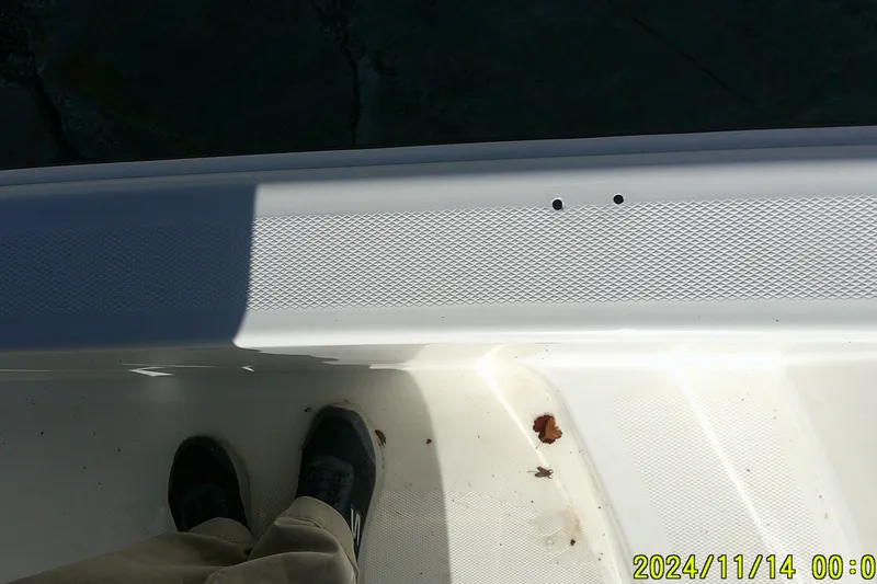 Slide: The Image of 2024 Mako Pro Skiff 19 CC deck with textured surface and shadow. - 23