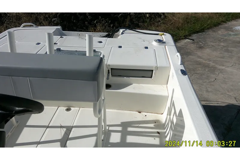 Slide: The Image of 2024 Mako Pro Skiff 19 CC boat interior with seating and storage compartments. - 25