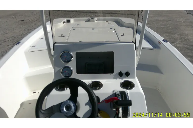 Slide: The Image of 2024 Mako Pro Skiff 19 CC boat console with steering wheel and gauges. - 28