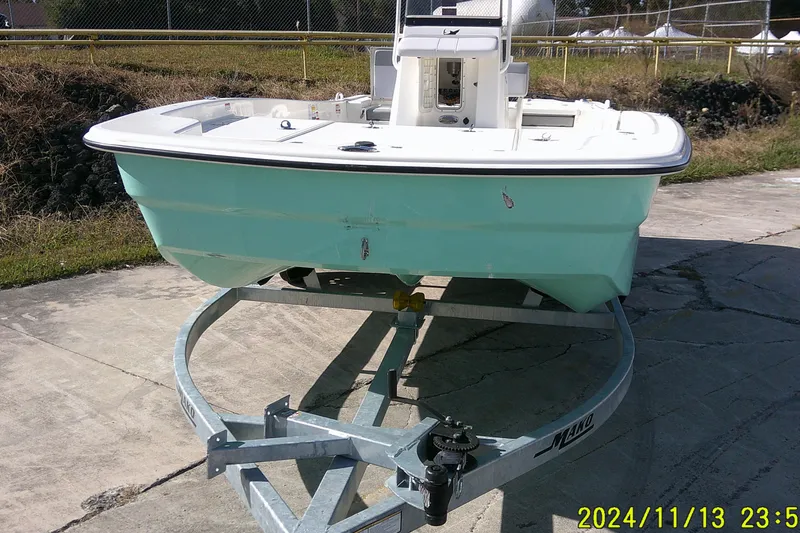 Slide: The Image of 2024 Mako Pro Skiff 19 CC boat on trailer, parked outdoors. - 3