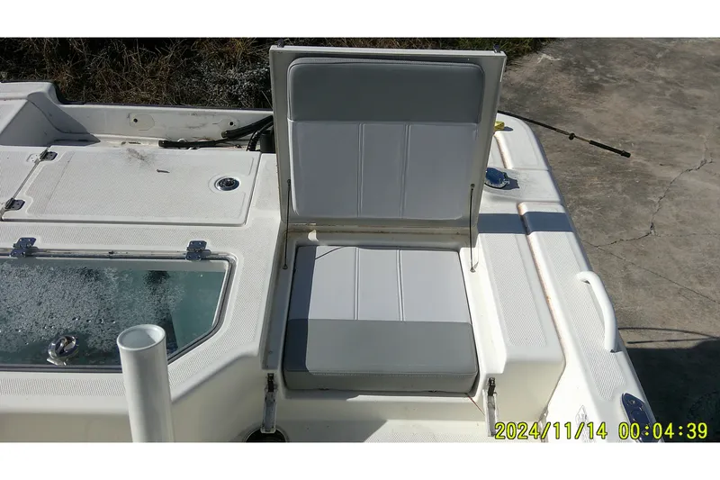 Slide: The Image of 2024 Mako Pro Skiff 19 CC boat seat and deck with storage compartment. - 32