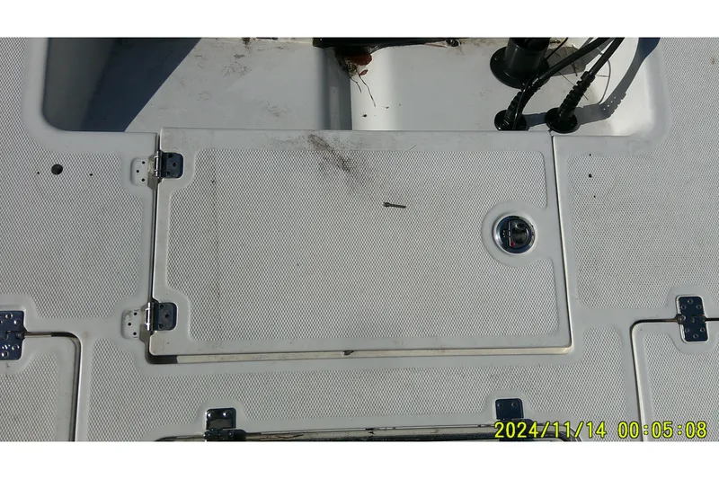 Slide: The Image of 2024 Mako Pro Skiff 19 CC deck with storage hatch and timestamp. - 35