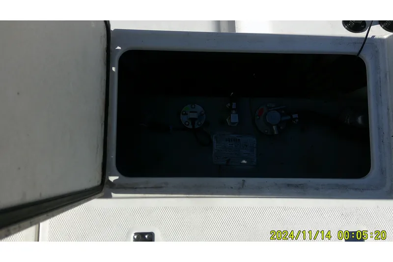 Slide: The Image of Open storage compartment on 2024 Mako Pro Skiff 19 CC boat. - 36