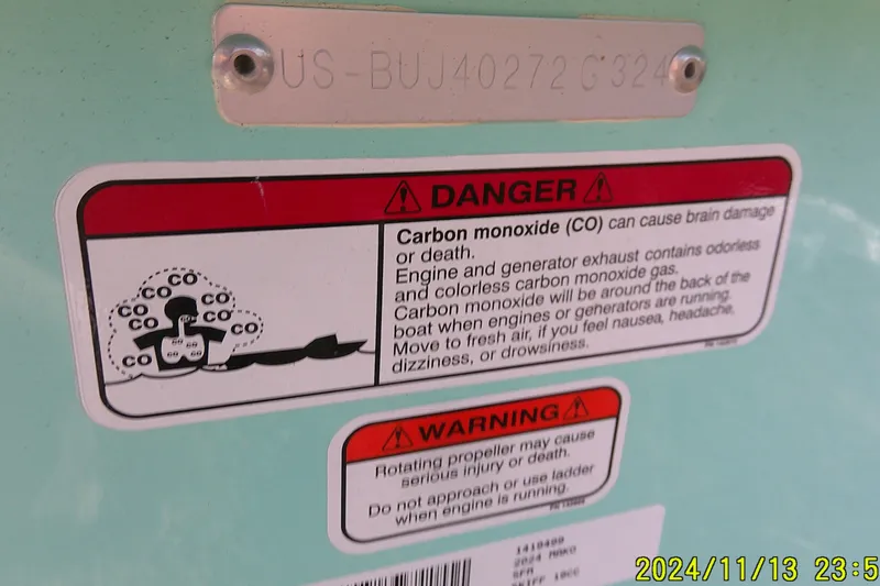 Slide: The Image of 2024 Mako Pro Skiff 19 CC warning labels about carbon monoxide and rotating propeller dangers. - 37
