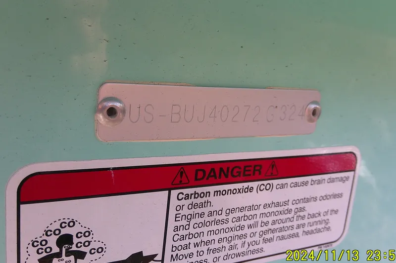 Slide: The Image of 2024 Mako Pro Skiff 19 CC hull identification and carbon monoxide warning label. - 38