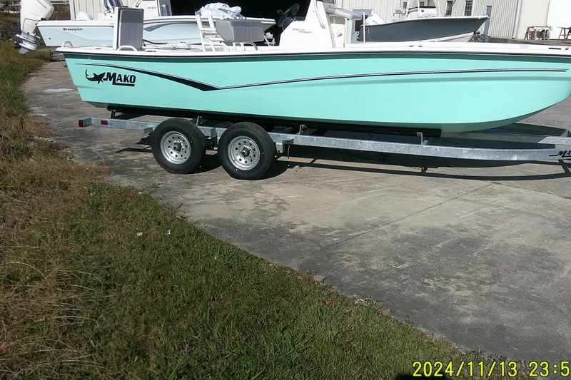 Slide: The Image of 2024 Mako Pro Skiff 19 CC boat on trailer, parked outdoors. - 5