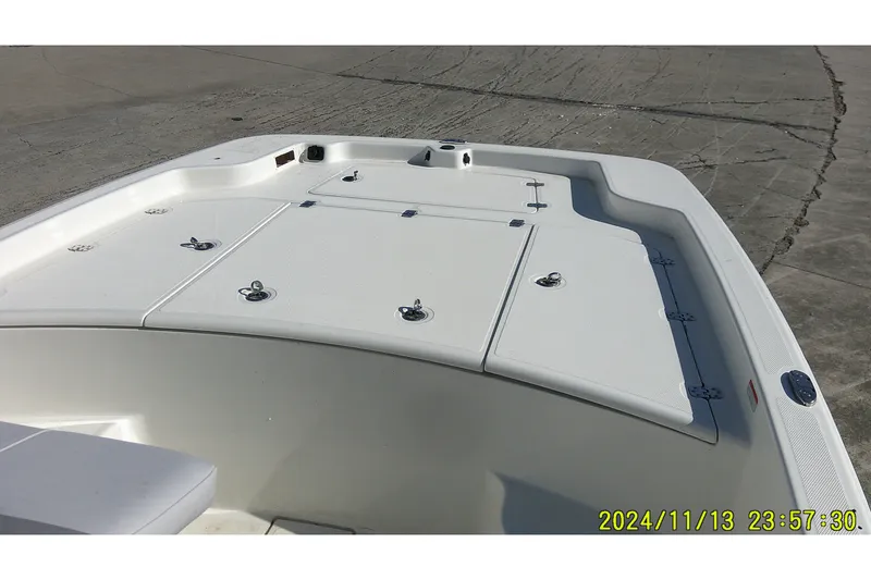 Slide: The Image of 2024 Mako Pro Skiff 19 CC boat deck with storage compartments. - 7