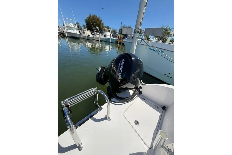 Slide: The Image of 2024 TwinVee 240 CFX CC boat with Mercury outboard motor at marina. - 10