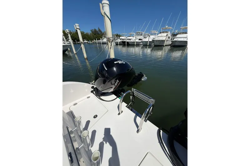Slide: The Image of 2024 TwinVee 240 CFX CC boat with Mercury outboard motor docked at marina. - 9