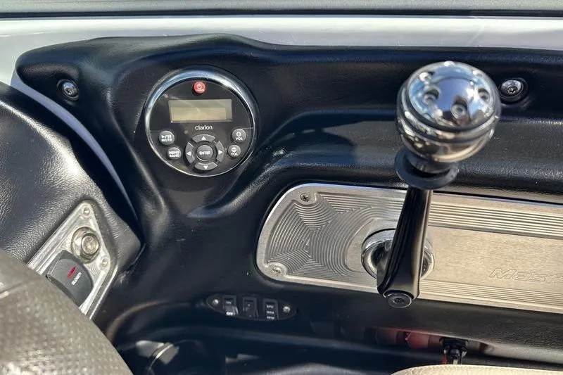 Slide: The Image of Dashboard of a 2005 Master Craft Pro Star 205 boat with controls and gear lever. - 10