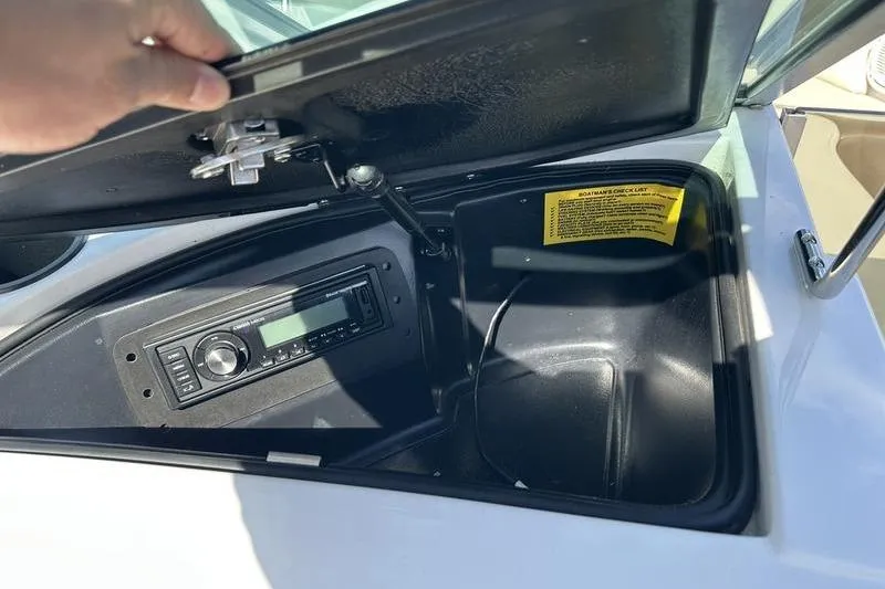 Slide: The Image of Open storage compartment in 2005 Master Craft Pro Star 205 boat with stereo system. - 11
