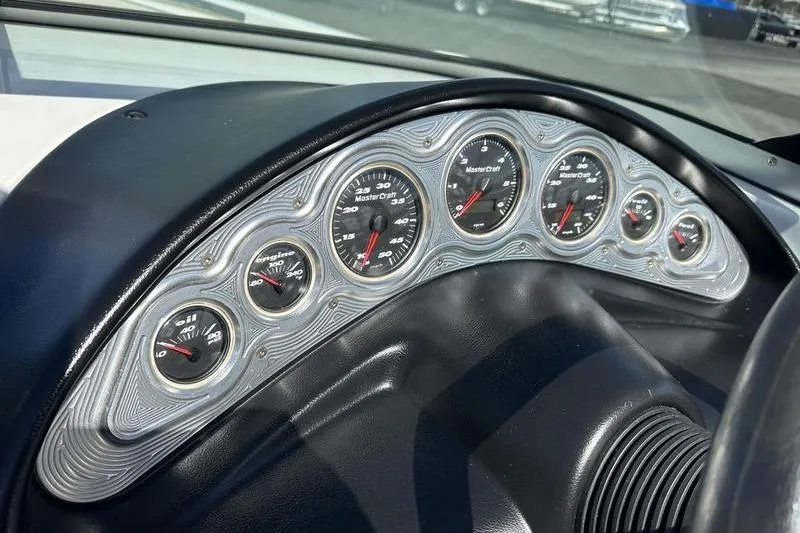 Slide: The Image of Dashboard of a 2005 Master Craft Pro Star 205 boat with multiple gauges. - 13