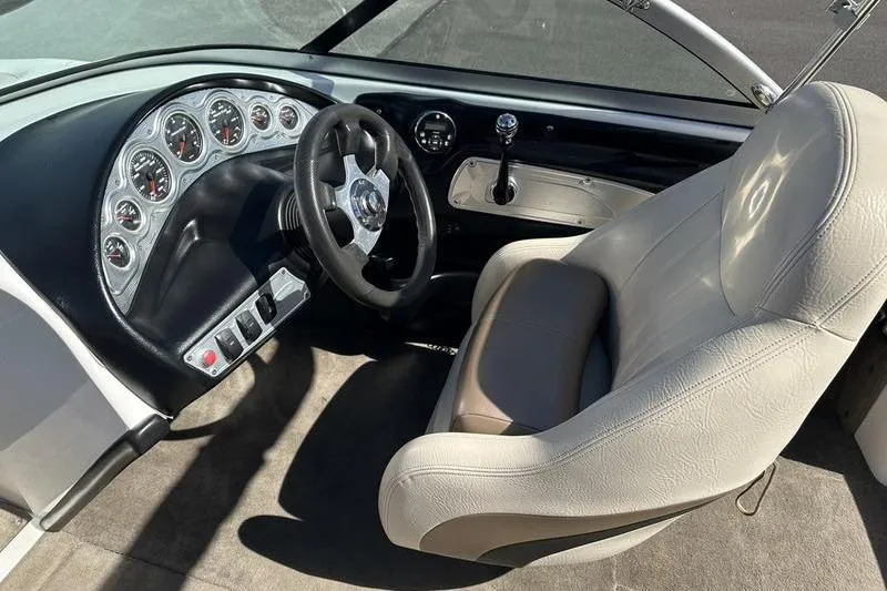 Slide: The Image of 2005 Master Craft Pro Star 205 boat interior with steering wheel and dashboard controls. - 14