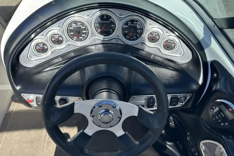Slide: The Image of Dashboard of a 2005 Master Craft Pro Star 205 boat with steering wheel and gauges. - 15