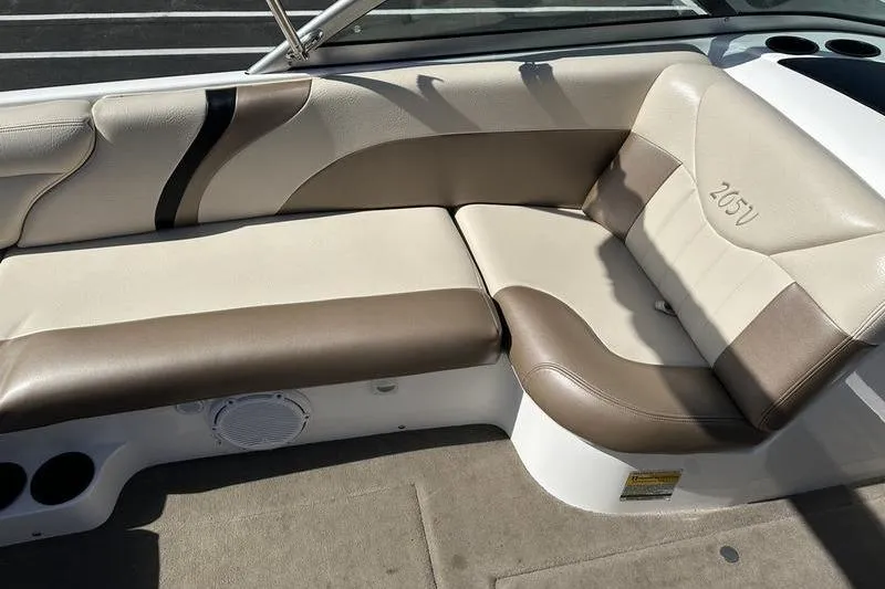 Slide: The Image of 2005 Master Craft Pro Star 205 boat interior with beige and brown seating. - 16