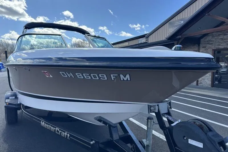 Slide: The Image of 2005 Master Craft Pro Star 205 boat on trailer, parked outside a building under a blue sky. - 6