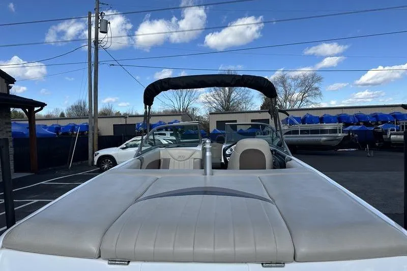 Slide: The Image of 2005 Master Craft Pro Star 205 boat with canopy, parked outdoors under blue sky. - 7