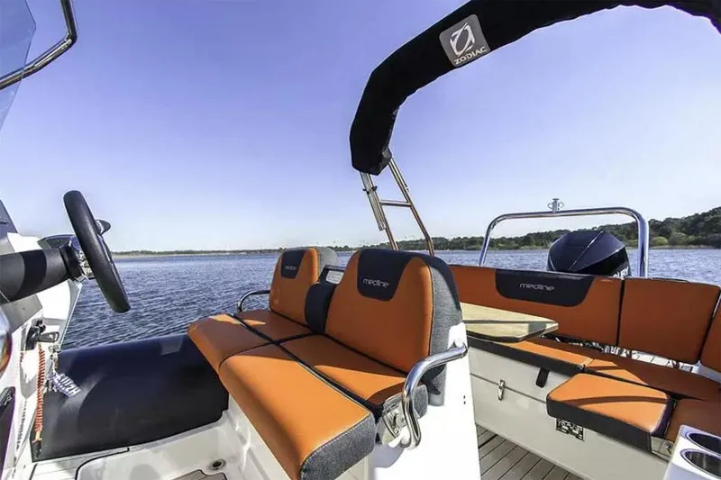 Slide: The Image of Manufacturer Provided Image: Zodiac Medline 6.8 boat 2026 with orange seats on calm water. - 2